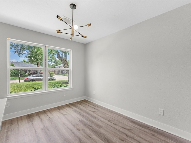 2515 Garapan St, Houston, TX 77091 - spare room featuring a chandelier and wood finished floors