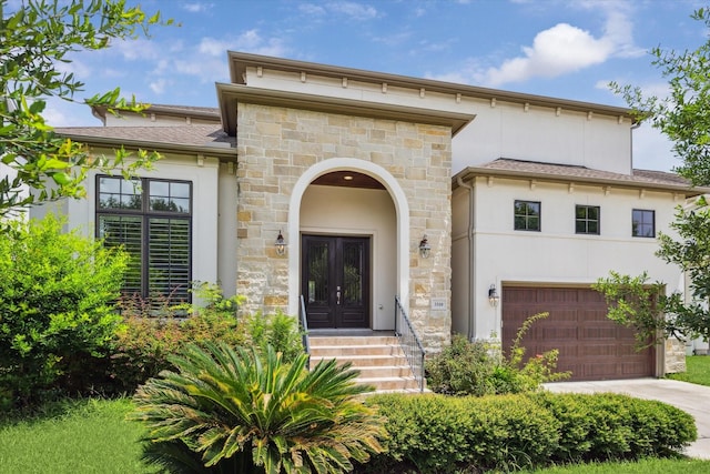 3310 Glen Haven Blvd, Houston, TX 77025 - view of front facade featuring stucco siding, french doors, driveway, a garage, and stone siding