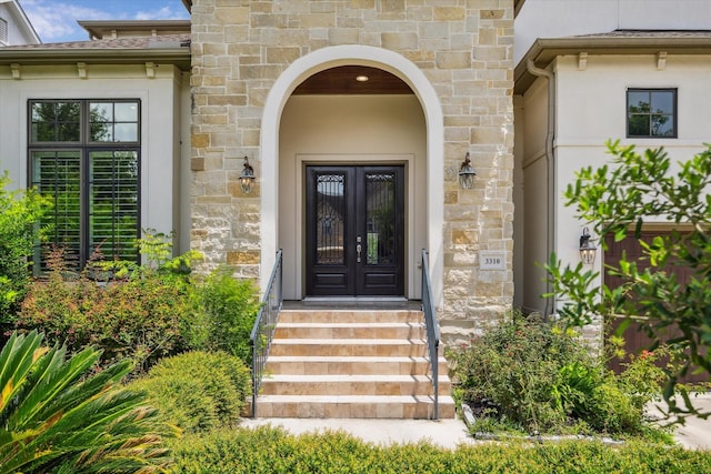 3310 Glen Haven Blvd, Houston, TX 77025 - view of exterior entry with french doors, stucco siding, and stone siding