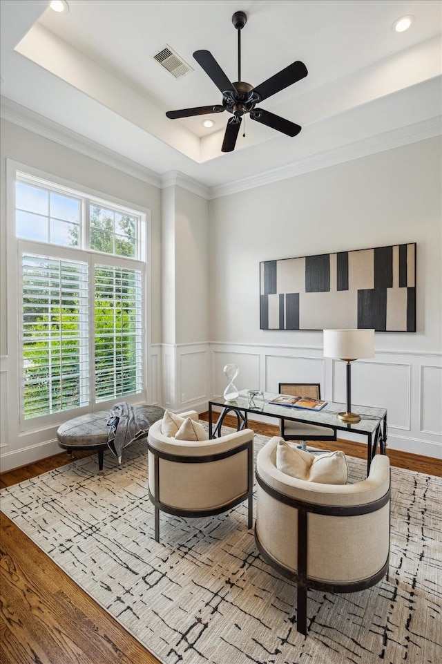 3310 Glen Haven Blvd, Houston, TX 77025 - sitting room with a decorative wall, a raised ceiling, wood finished floors, ornamental molding, and recessed lighting