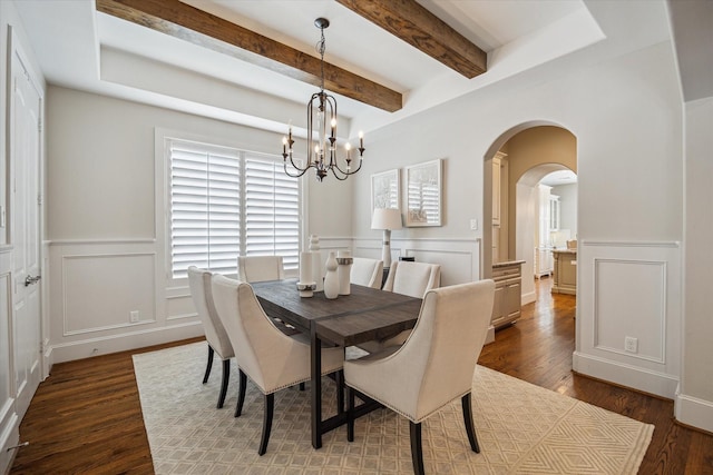 3310 Glen Haven Blvd, Houston, TX 77025 - dining space with a decorative wall, dark wood-style flooring, beamed ceiling, arched walkways, and wainscoting