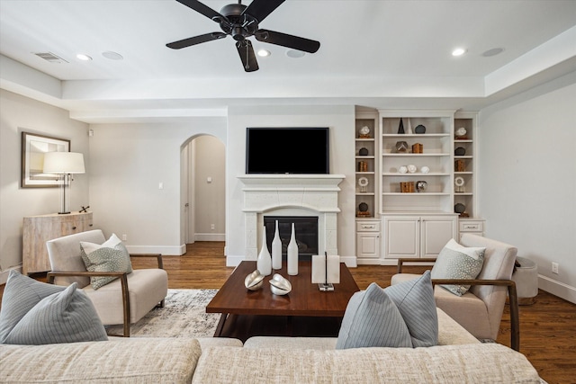 3310 Glen Haven Blvd, Houston, TX 77025 - living area featuring arched walkways, wood finished floors, ceiling fan, a glass covered fireplace, and recessed lighting