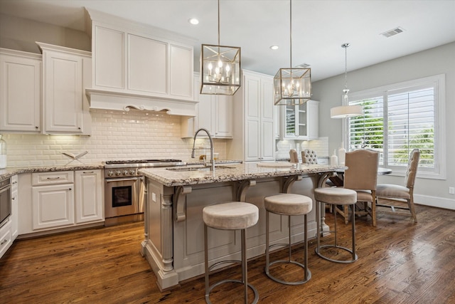 3310 Glen Haven Blvd, Houston, TX 77025 - kitchen featuring double oven range, white cabinets, dark wood finished floors, decorative backsplash, and recessed lighting