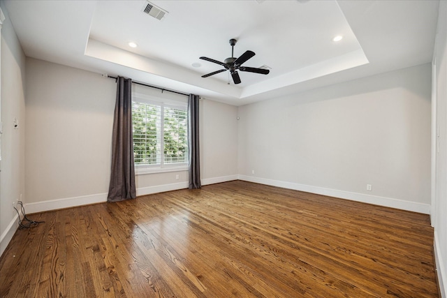 3310 Glen Haven Blvd, Houston, TX 77025 - empty room featuring a tray ceiling, wood finished floors, recessed lighting, and a ceiling fan