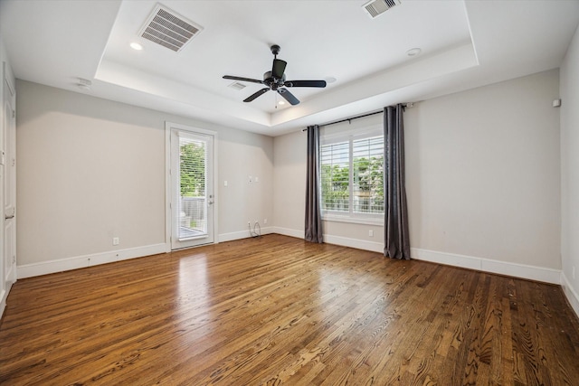 3310 Glen Haven Blvd, Houston, TX 77025 - spare room with a tray ceiling, wood finished floors, a ceiling fan, and a smoke detector