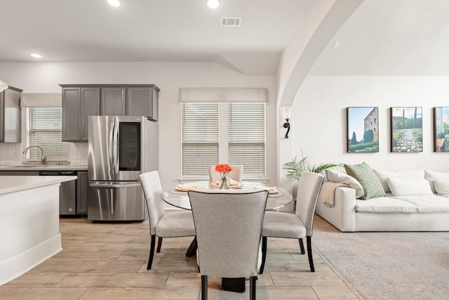 6023 Dovetail Cliff Ct, Katy, TX 77493 - dining space with light wood-style floors, healthy amount of natural light, arched walkways, and recessed lighting