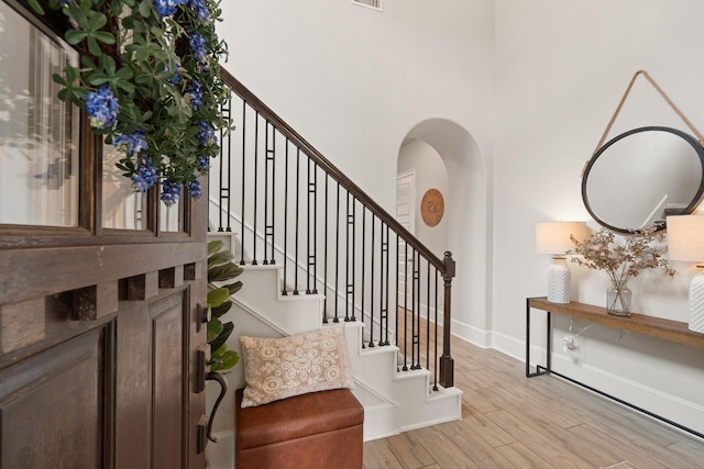 6023 Dovetail Cliff Ct, Katy, TX 77493 - stairway featuring wood finished floors and arched walkways