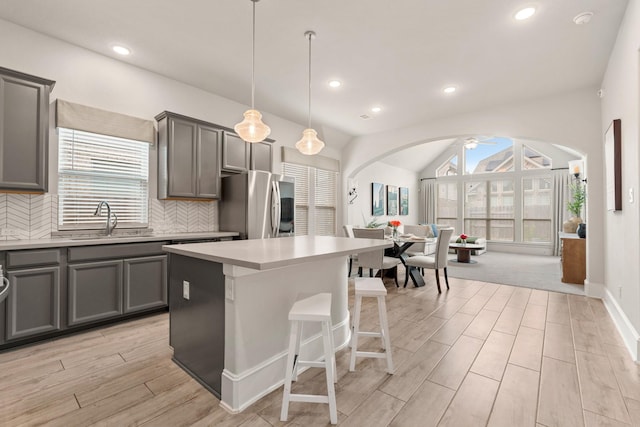 6023 Dovetail Cliff Ct, Katy, TX 77493 - kitchen featuring smart refrigerator, arched walkways, gray cabinetry, a ceiling fan, and recessed lighting