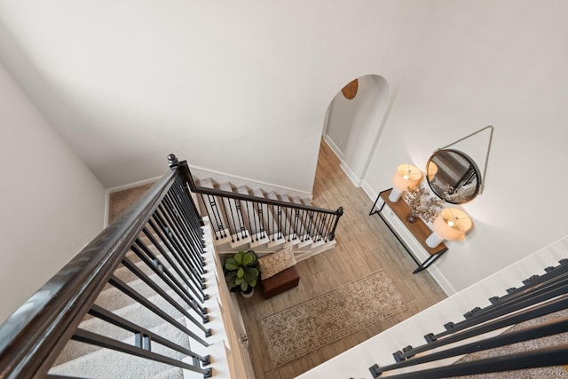 6023 Dovetail Cliff Ct, Katy, TX 77493 - stairway featuring wood finished floors and arched walkways