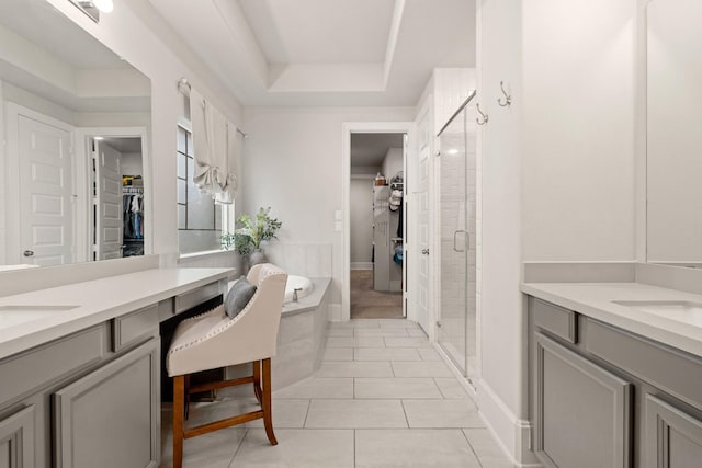 6023 Dovetail Cliff Ct, Katy, TX 77493 - full bath featuring two vanities, a walk in closet, a stall shower, and a bath
