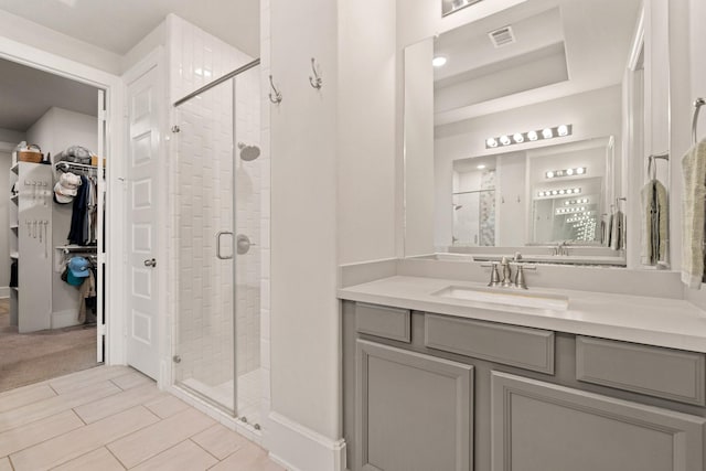 6023 Dovetail Cliff Ct, Katy, TX 77493 - bathroom featuring a stall shower, a spacious closet, and vanity
