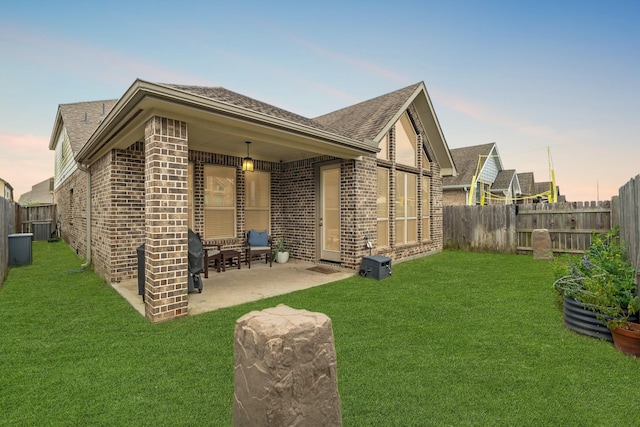 6023 Dovetail Cliff Ct, Katy, TX 77493 - rear view of property with brick siding, a shingled roof, and a patio area