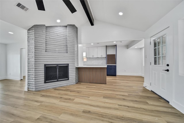 9622 Clanton St, Houston, TX 77080 - unfurnished living room featuring beam ceiling, light wood-style flooring, a fireplace, recessed lighting, and high vaulted ceiling