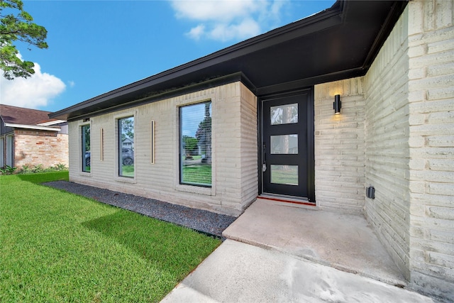 9622 Clanton St, Houston, TX 77080 - view of exterior entry featuring a lawn and brick siding