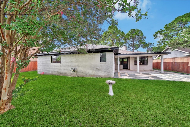 9622 Clanton St, Houston, TX 77080 - rear view of house with brick siding, a patio, a fenced backyard, and a chimney