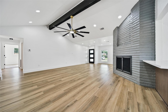 9622 Clanton St, Houston, TX 77080 - unfurnished living room featuring a large fireplace, beam ceiling, ceiling fan, plenty of natural light, and high vaulted ceiling