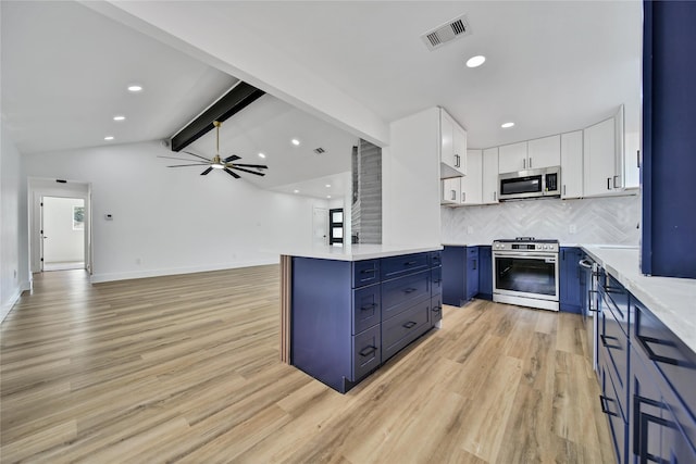 9622 Clanton St, Houston, TX 77080 - kitchen featuring appliances with stainless steel finishes, blue cabinets, tasteful backsplash, white cabinetry, and light wood-style floors