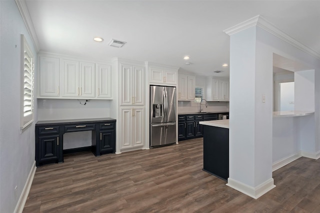 9210 Rangely Dr, Houston, TX 77055 - kitchen featuring stainless steel fridge, dark wood-style floors, white cabinets, recessed lighting, and light countertops