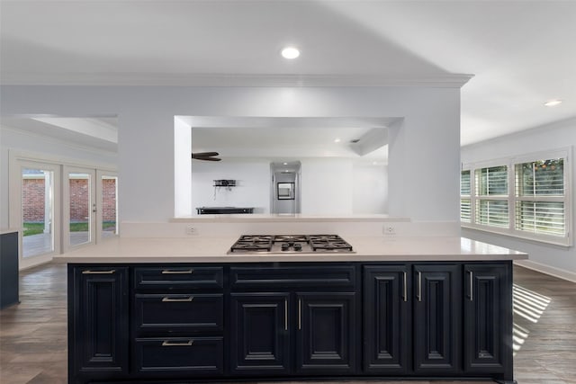 9210 Rangely Dr, Houston, TX 77055 - kitchen featuring dark cabinets, ornamental molding, stainless steel gas stovetop, light countertops, and recessed lighting