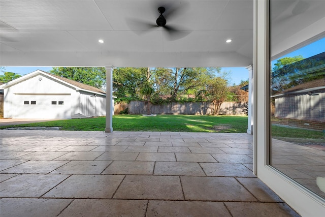 9210 Rangely Dr, Houston, TX 77055 - fenced backyard featuring an outbuilding, ceiling fan, and a patio area