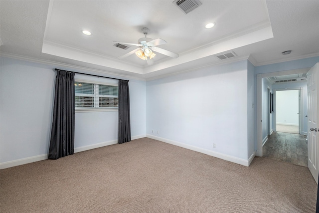 9210 Rangely Dr, Houston, TX 77055 - spare room featuring a tray ceiling, ornamental molding, attic access, carpet, and ceiling fan