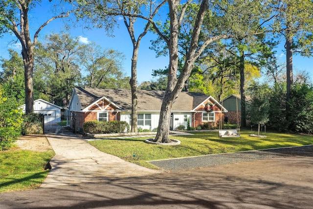 9210 Rangely Dr, Houston, TX 77055 - tudor-style house with driveway, a gate, and brick siding