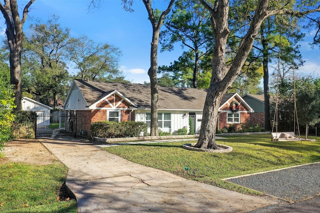 9210 Rangely Dr, Houston, TX 77055 - view of front of home with brick siding, a front yard, concrete driveway, and a gate