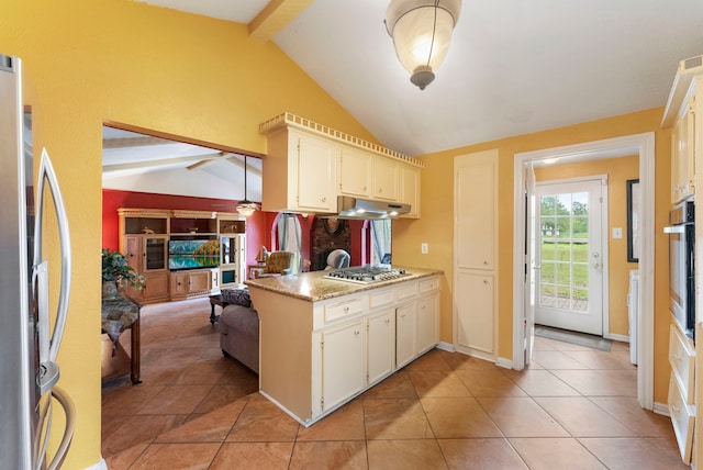 2902 Rainwood St, Spring, TX 77388 - kitchen with stainless steel appliances, a ceiling fan, under cabinet range hood, light tile patterned floors, and white cabinetry