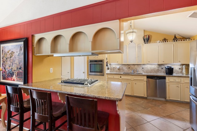 2902 Rainwood St, Spring, TX 77388 - kitchen with stainless steel appliances, lofted ceiling, decorative backsplash, a peninsula, and a kitchen breakfast bar