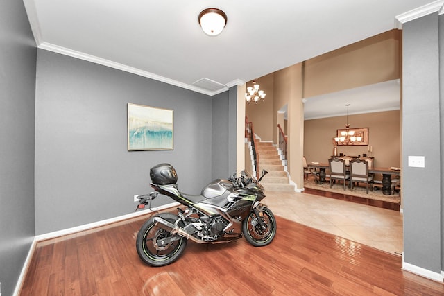 13723 Playa Lucia Ct, Houston, TX 77044 - workout area featuring a chandelier, crown molding, and wood finished floors