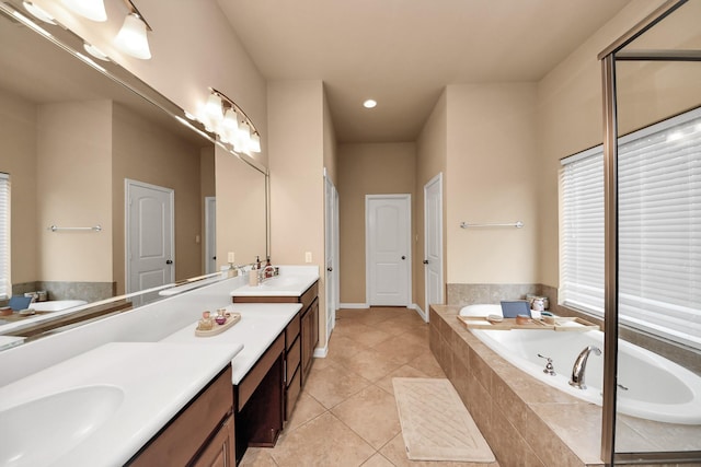13723 Playa Lucia Ct, Houston, TX 77044 - bathroom featuring double vanity, a garden tub, tile patterned flooring, recessed lighting, and healthy amount of natural light