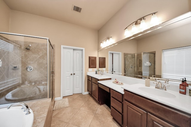 13723 Playa Lucia Ct, Houston, TX 77044 - bathroom with double vanity, a shower stall, a garden tub, and tile patterned flooring