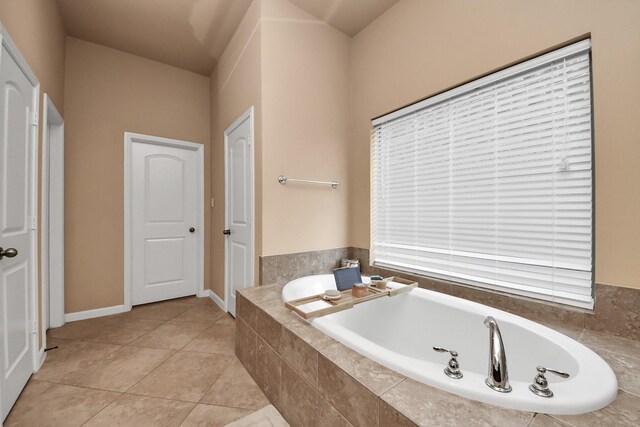 13723 Playa Lucia Ct, Houston, TX 77044 - full bathroom with a garden tub and tile patterned flooring