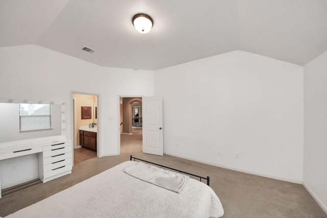 13723 Playa Lucia Ct, Houston, TX 77044 - bedroom with vaulted ceiling, carpet floors, a desk, and connected bathroom