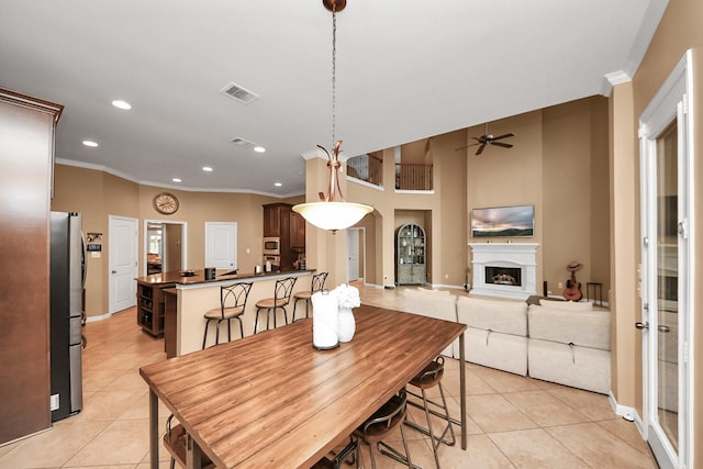 13723 Playa Lucia Ct, Houston, TX 77044 - dining room featuring light tile patterned flooring, ornamental molding, recessed lighting, ceiling fan, and a fireplace with raised hearth