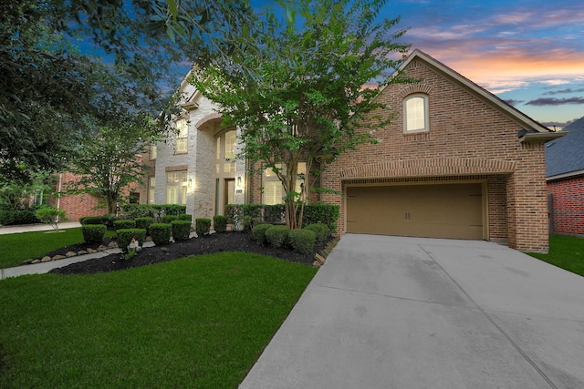 13723 Playa Lucia Ct, Houston, TX 77044 - view of front of property featuring concrete driveway, brick siding, and a front lawn