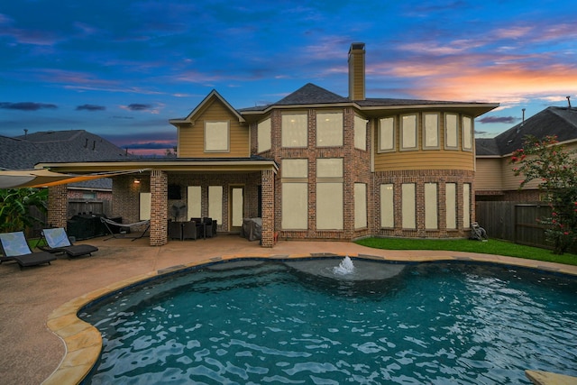 13723 Playa Lucia Ct, Houston, TX 77044 - back of property featuring a fenced backyard, a patio, brick siding, and a chimney