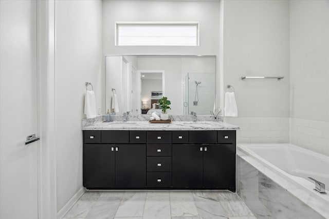 805 Sandman St, Houston, TX 77007 - bathroom featuring a garden tub, double vanity, marble look tiles, walk in shower, and a towering ceiling
