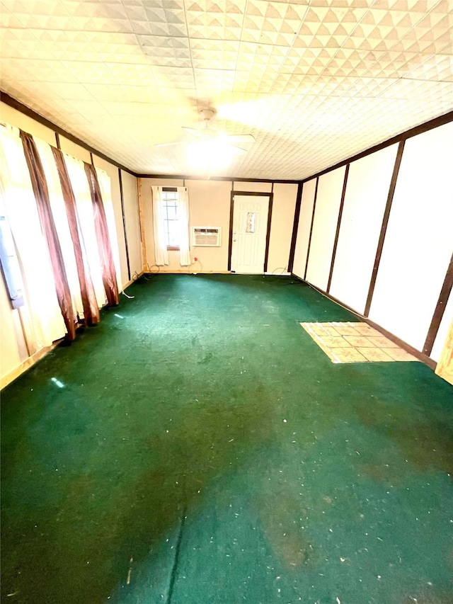 206 E Rogers St, Ganado, TX 77962 - carpeted spare room featuring a wall mounted air conditioner and a ceiling fan