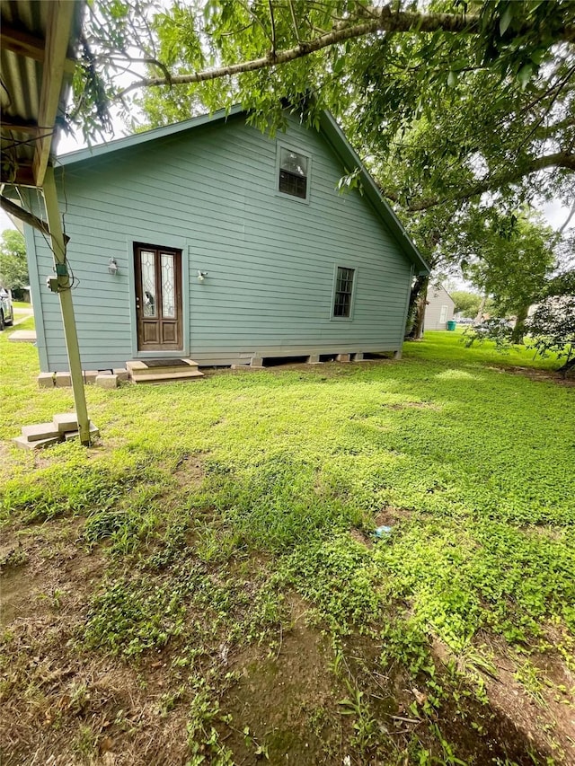 206 E Rogers St, Ganado, TX 77962 - rear view of house with a lawn and french doors