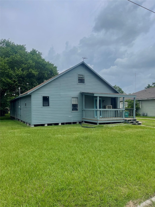 206 E Rogers St, Ganado, TX 77962 - rear view of property with a deck and a yard
