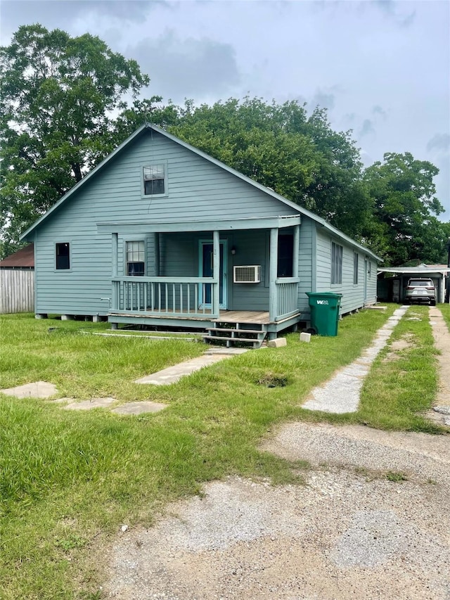 206 E Rogers St, Ganado, TX 77962 - view of front of house with covered porch and a wall mounted AC