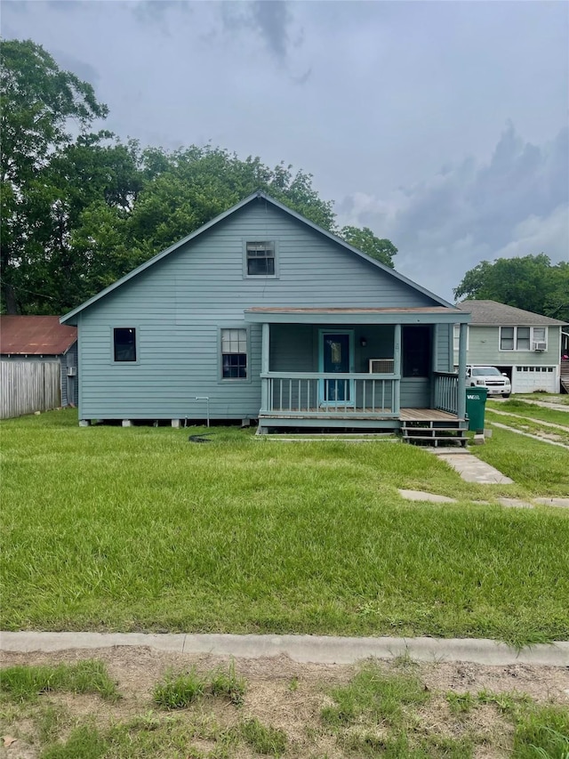 206 E Rogers St, Ganado, TX 77962 - view of front of home with a front yard and covered porch