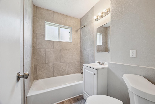 210 Laurel St, Lake Jackson, TX 77566 - full bath featuring vanity, tub / shower combination, healthy amount of natural light, wood finished floors, and a textured wall
