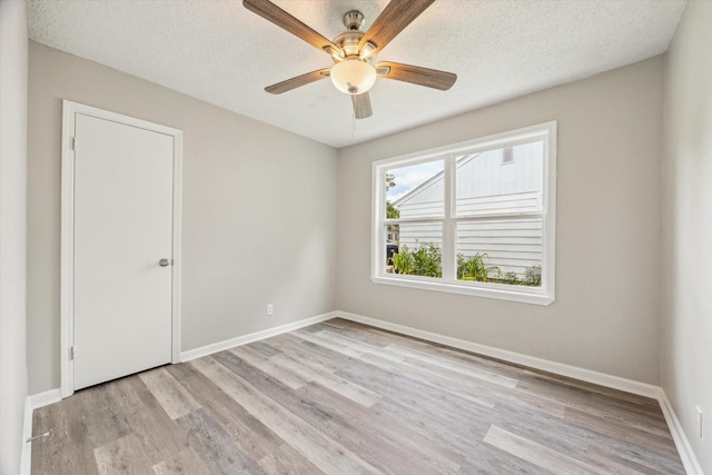 210 Laurel St, Lake Jackson, TX 77566 - unfurnished room featuring light wood-style floors, ceiling fan, and a textured ceiling