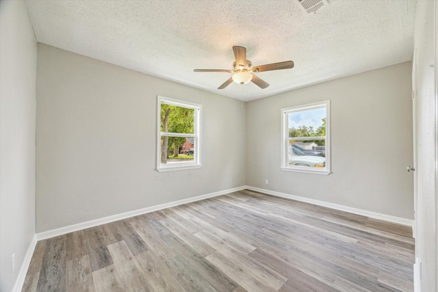 210 Laurel St, Lake Jackson, TX 77566 - unfurnished room featuring wood finished floors, ceiling fan, and a textured ceiling
