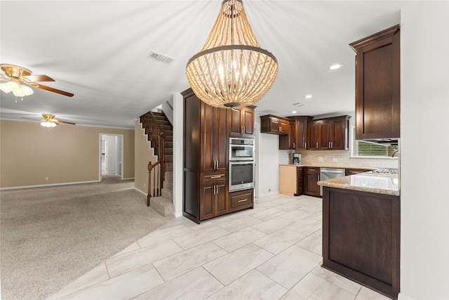 18910 Casper Dr, Spring, TX 77373 - kitchen with appliances with stainless steel finishes, dark brown cabinets, backsplash, a ceiling fan, and recessed lighting