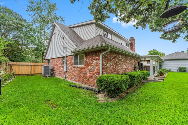 18910 Casper Dr, Spring, TX 77373 - view of side of home featuring brick siding, roof with shingles, and a chimney