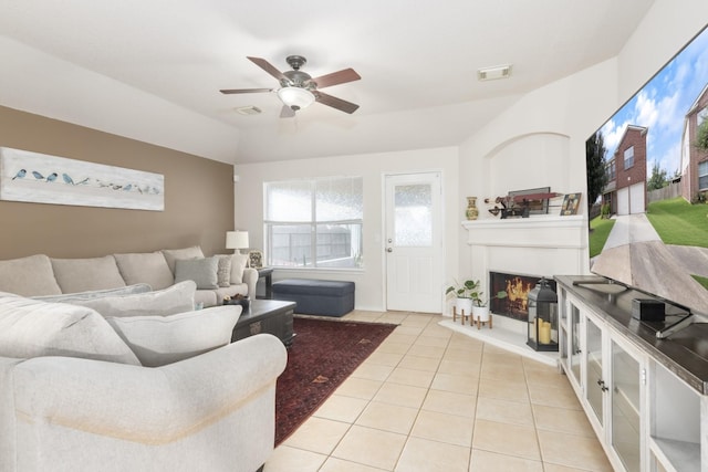 14903 Sugar Sweet Dr, Sugar Land, TX 77498 - living area with tile patterned flooring, ceiling fan, and a glass covered fireplace