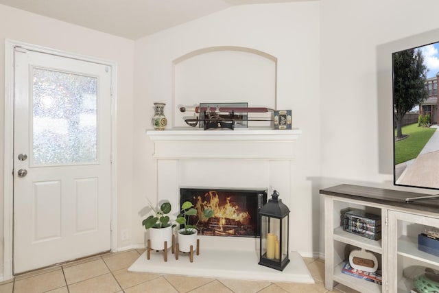 14903 Sugar Sweet Dr, Sugar Land, TX 77498 - tiled entrance foyer featuring a warm lit fireplace and baseboards